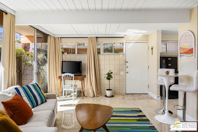 living room with tile walls and light tile patterned floors