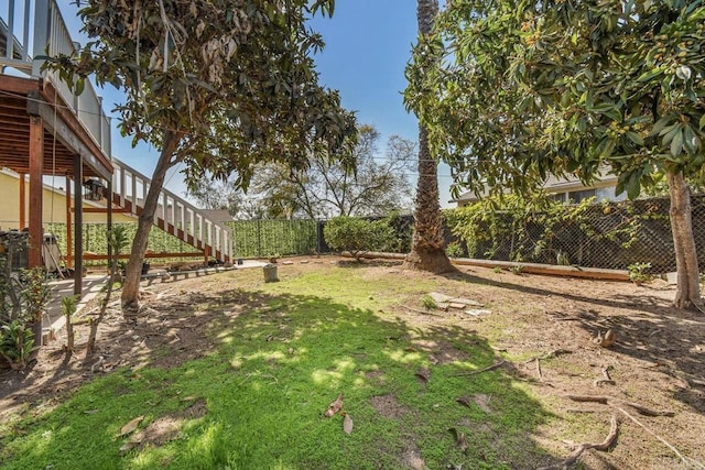 view of yard featuring stairs and a fenced backyard