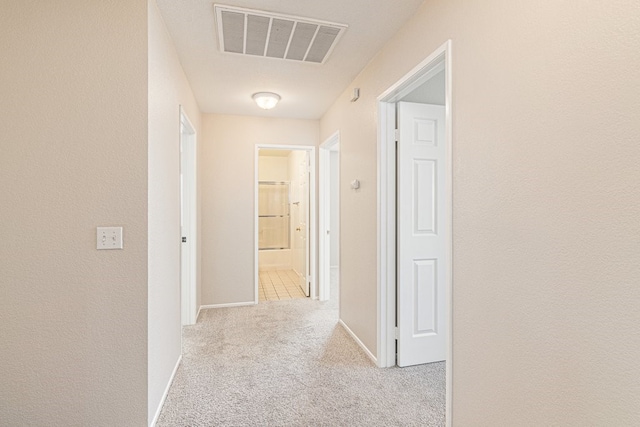 hall featuring light colored carpet