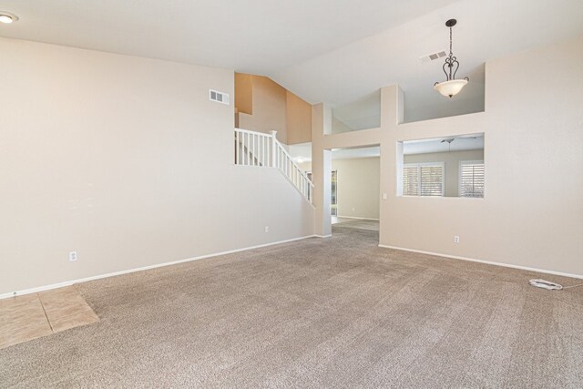 unfurnished room with ceiling fan, carpet floors, and high vaulted ceiling