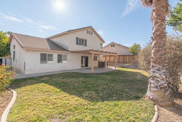 back of house with a lawn and a patio area