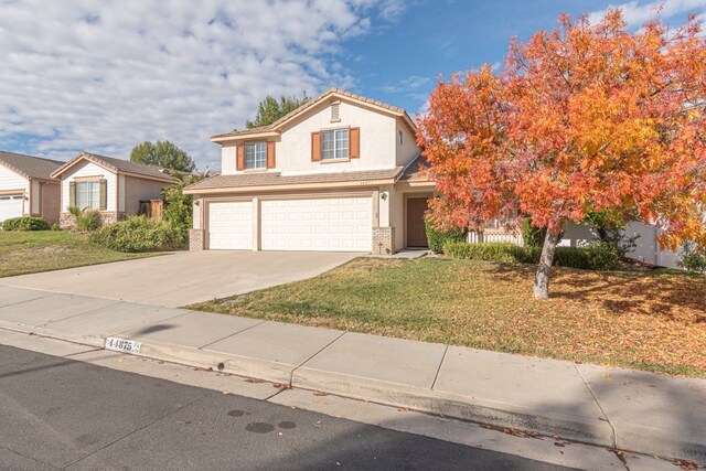 front of property featuring a front yard and a garage