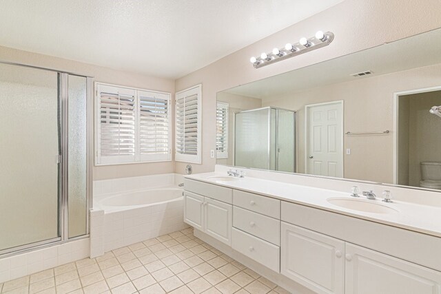 full bathroom featuring tile patterned floors, toilet, vanity, and shower with separate bathtub