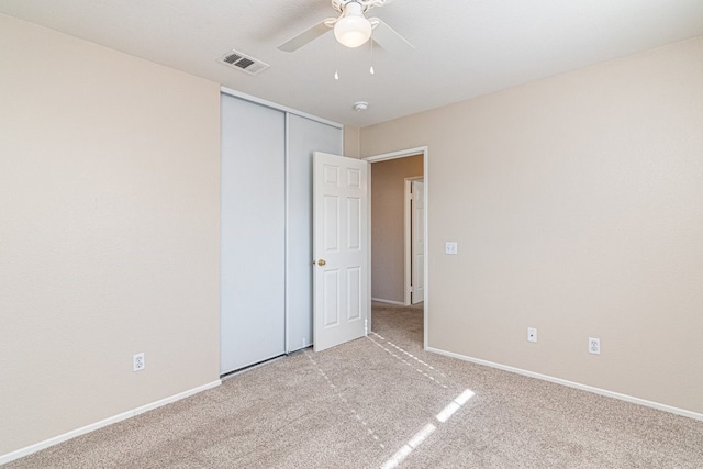 empty room with light colored carpet and ceiling fan