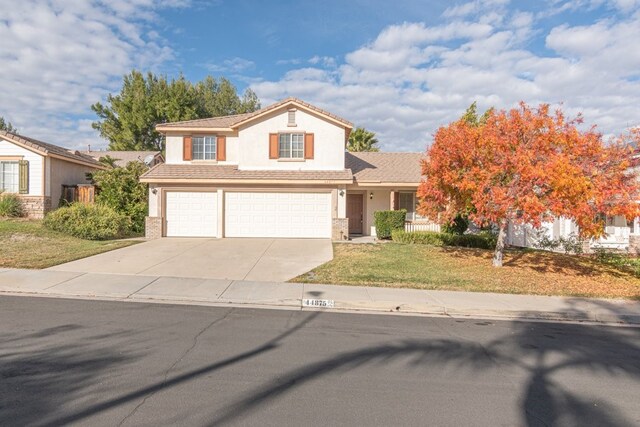 view of front of house featuring a front yard and a garage