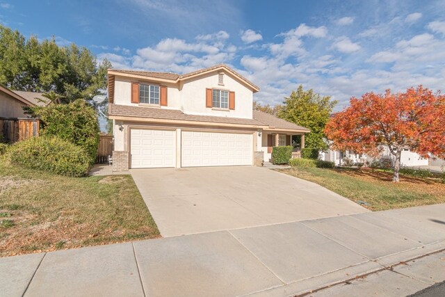 view of front of house featuring a garage and a front yard