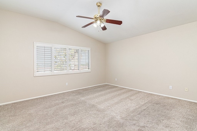 carpeted empty room featuring ceiling fan and lofted ceiling