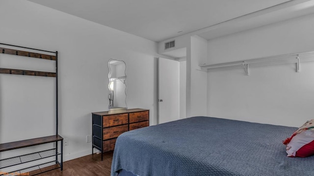 bedroom with dark hardwood / wood-style flooring