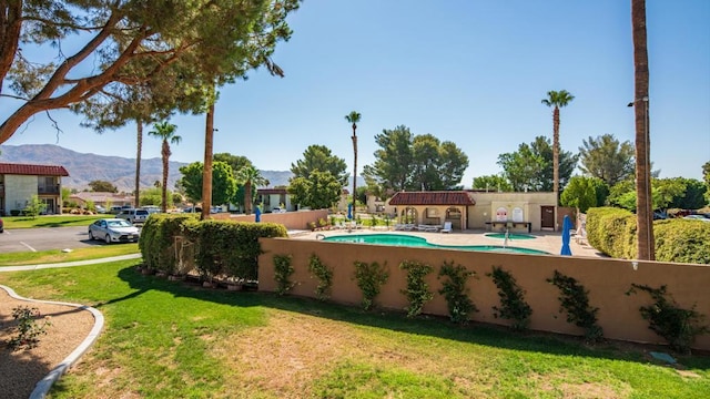 view of pool featuring a mountain view and a lawn