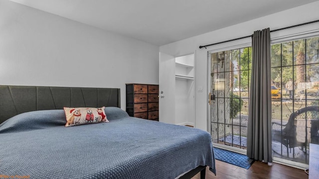 bedroom featuring access to exterior and hardwood / wood-style flooring