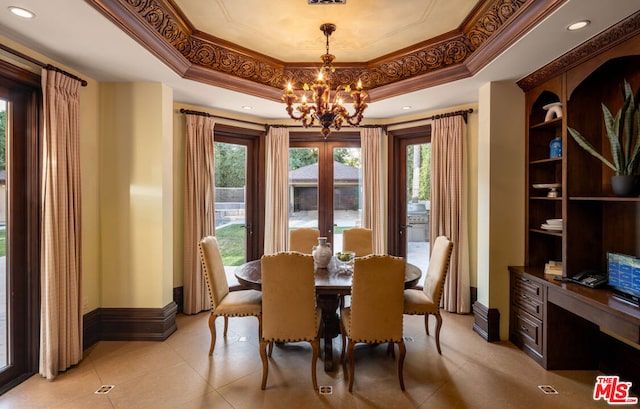 dining area featuring light tile patterned floors, an inviting chandelier, ornamental molding, and a raised ceiling