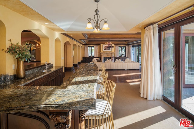 tiled dining room with sink and an inviting chandelier