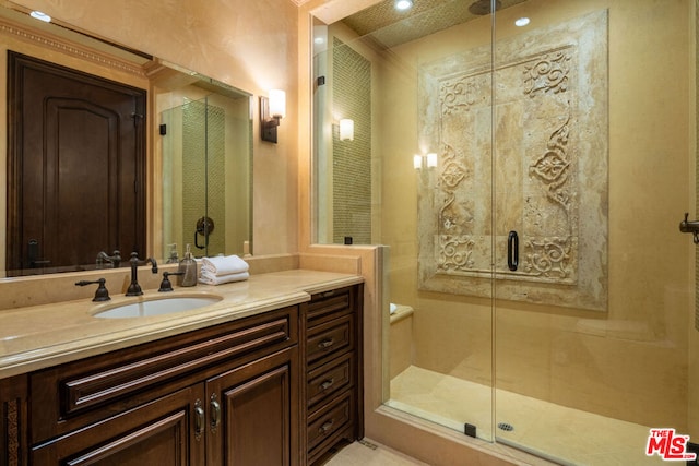 bathroom with an enclosed shower and vanity