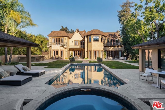 view of pool with a gazebo, a patio area, and an in ground hot tub