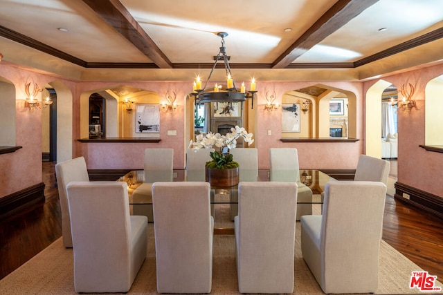 dining space with beam ceiling, a notable chandelier, crown molding, and hardwood / wood-style floors