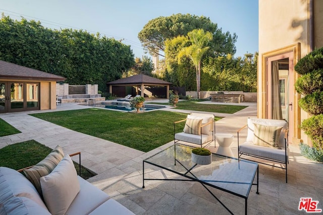 view of patio / terrace with an outdoor hangout area, a gazebo, and an outdoor structure