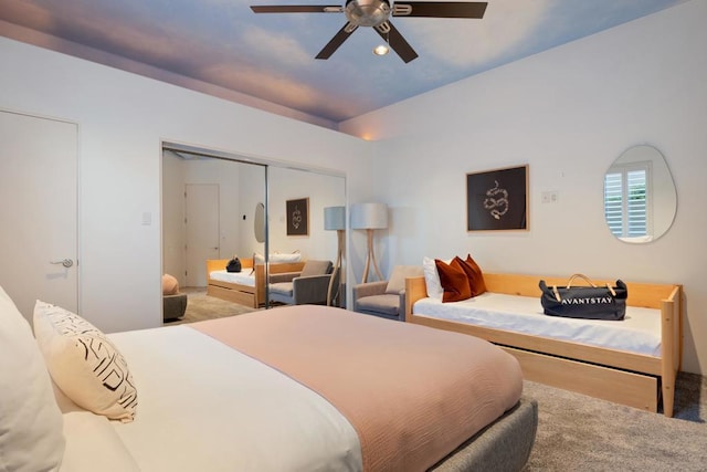 carpeted bedroom with ceiling fan and a closet