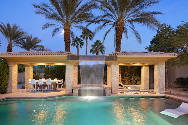 view of swimming pool with a patio area and ceiling fan