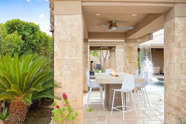 view of patio with ceiling fan and exterior bar