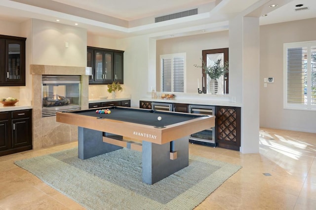 playroom with light tile patterned flooring, a multi sided fireplace, billiards, and beverage cooler