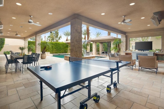 view of patio featuring ceiling fan and an outdoor kitchen