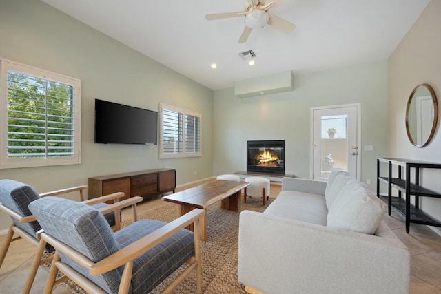 tiled living room with plenty of natural light and ceiling fan