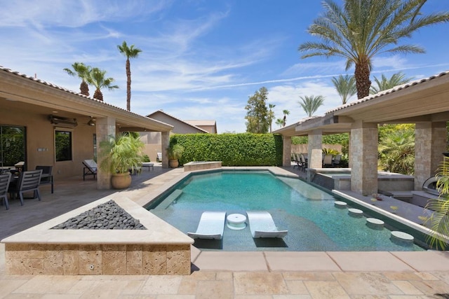 view of swimming pool featuring an in ground hot tub, an outdoor fire pit, and a patio