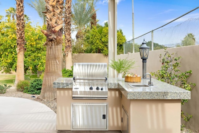 view of patio / terrace featuring area for grilling and sink