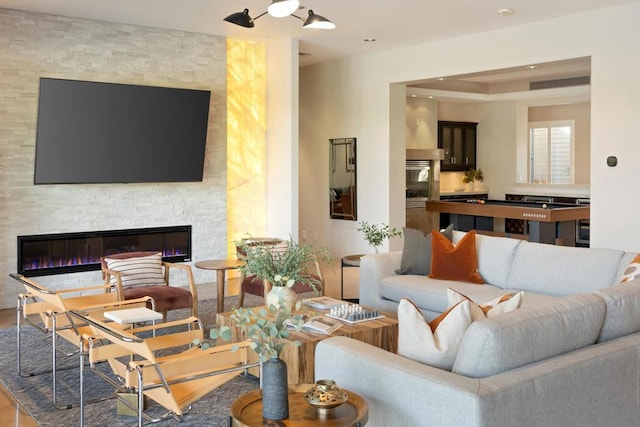 living room featuring a stone fireplace