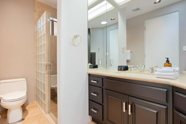 bathroom featuring tile patterned floors, vanity, toilet, and a shower with shower door