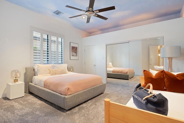 carpeted bedroom featuring ceiling fan and a closet