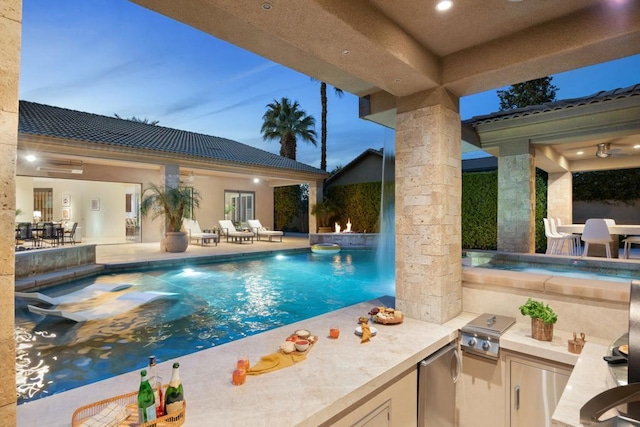 pool at dusk featuring a patio and area for grilling