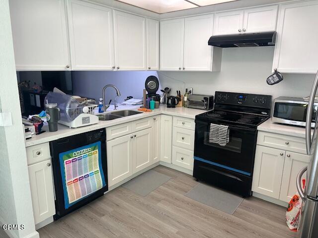 kitchen with sink, light hardwood / wood-style floors, white cabinetry, and black appliances