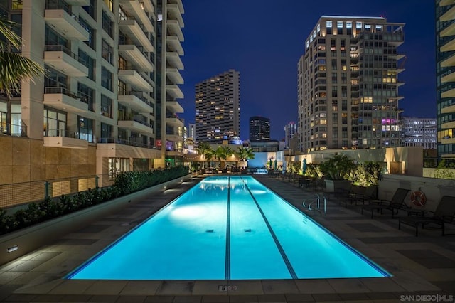 pool at twilight with a patio