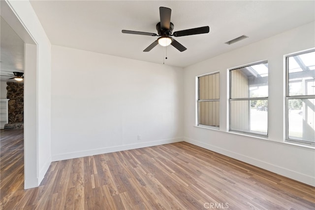 spare room with ceiling fan and hardwood / wood-style flooring