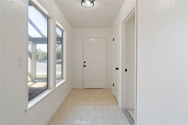 entryway with light tile patterned floors