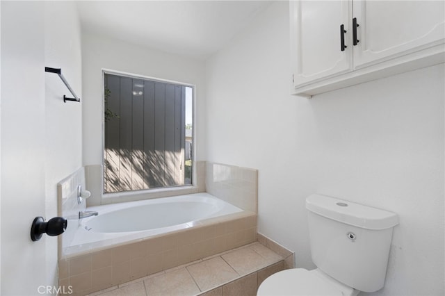 bathroom with tiled bath and toilet