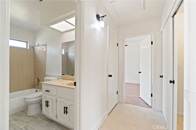 full bathroom with vanity, toilet, wood-type flooring, and tiled shower / bath