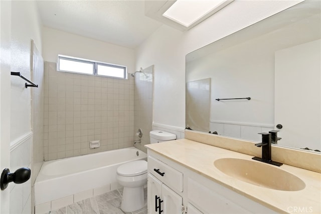 full bathroom featuring vanity, toilet, and tiled shower / bath