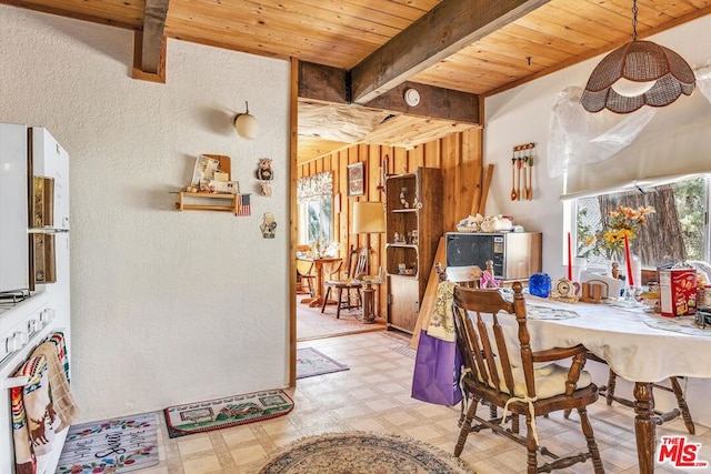 dining area with beam ceiling and wooden ceiling