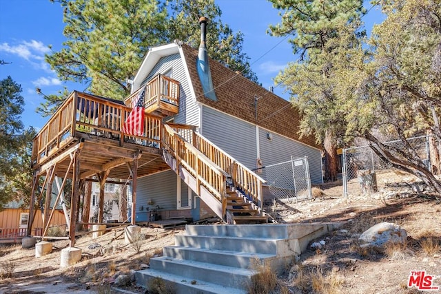 rear view of property with a wooden deck