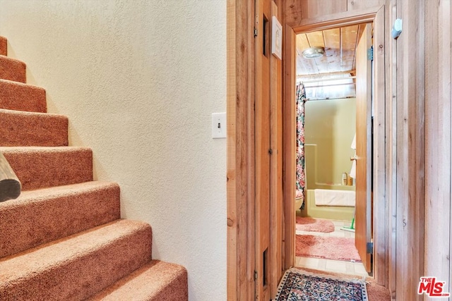 staircase featuring tile patterned flooring