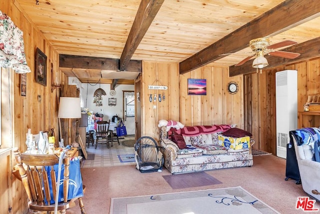 living room with wood walls and beamed ceiling