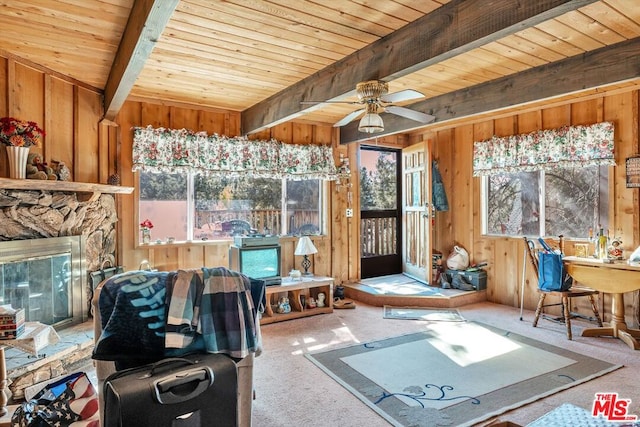 interior space with beam ceiling, a wealth of natural light, wooden ceiling, and ceiling fan