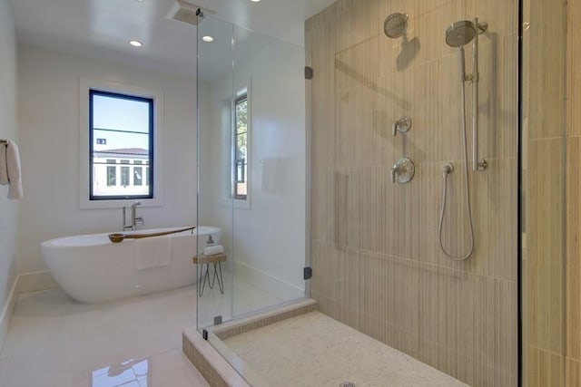 bathroom with tile patterned floors and shower with separate bathtub