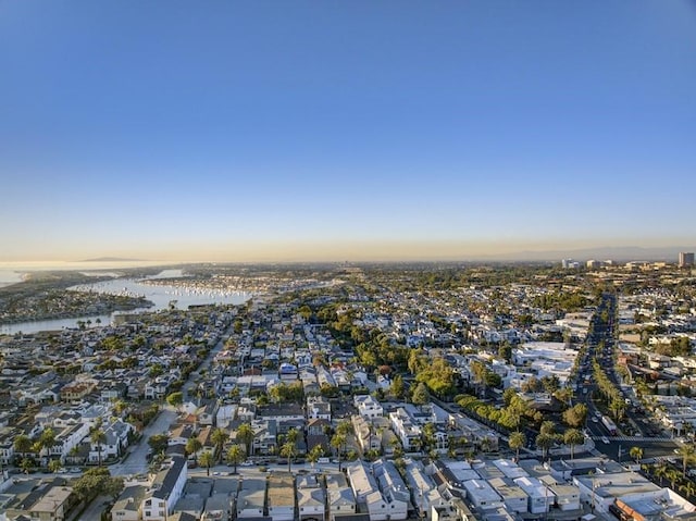 aerial view at dusk featuring a water view