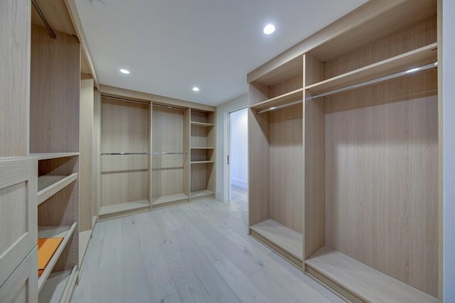 spacious closet featuring light hardwood / wood-style floors