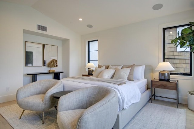 bedroom featuring vaulted ceiling and light hardwood / wood-style flooring