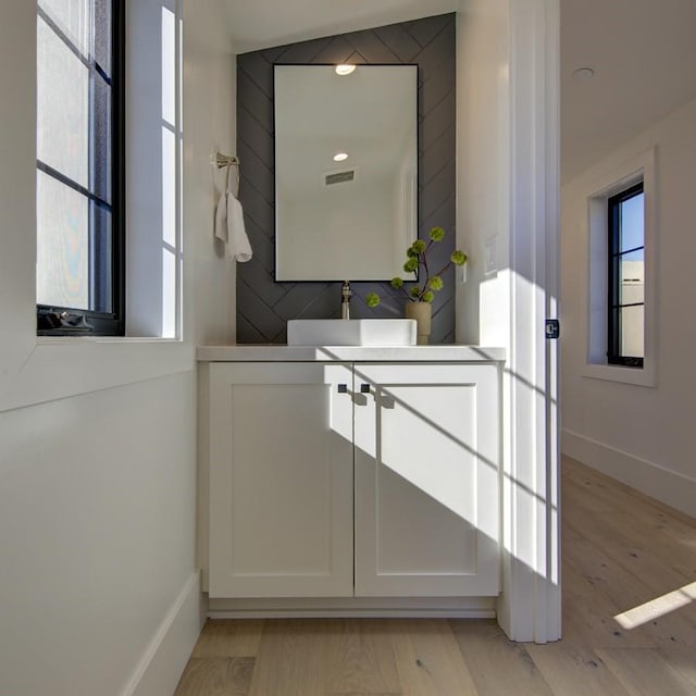 interior space with hardwood / wood-style flooring and vanity