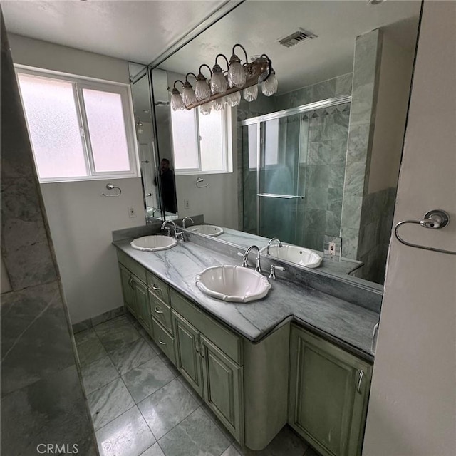 bathroom featuring plenty of natural light, vanity, and an enclosed shower